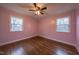 Charming bedroom with hardwood floors, ceiling fan, and pink walls at 802 S Sellars Mill Rd, Burlington, NC 27217