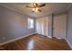 Spacious bedroom with hardwood floors, ceiling fan, and built-in closet at 802 S Sellars Mill Rd, Burlington, NC 27217