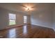 Bright bedroom with hardwood floors and ceiling fan at 802 S Sellars Mill Rd, Burlington, NC 27217