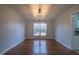 Bright dining room with hardwood floors and modern light fixture at 802 S Sellars Mill Rd, Burlington, NC 27217