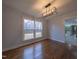 Bright dining room with hardwood floors and modern light fixture at 802 S Sellars Mill Rd, Burlington, NC 27217