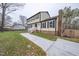 Two-story house with brick and siding, featuring a side view and landscaped lawn at 802 S Sellars Mill Rd, Burlington, NC 27217