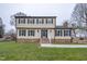 Two-story house with brick and siding, featuring a front porch and landscaped lawn at 802 S Sellars Mill Rd, Burlington, NC 27217
