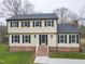Two-story house with brick and siding, featuring a front porch and landscaped lawn at 802 S Sellars Mill Rd, Burlington, NC 27217