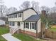 Two-story house with brick and siding, featuring a side view and landscaped lawn at 802 S Sellars Mill Rd, Burlington, NC 27217