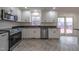 Modern kitchen with stainless steel appliances and granite countertops at 802 S Sellars Mill Rd, Burlington, NC 27217