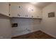 Bright laundry room with white cabinets and wood-look tile floor at 802 S Sellars Mill Rd, Burlington, NC 27217