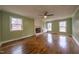 Living room features wood floors, built-ins, and a brick fireplace at 802 S Sellars Mill Rd, Burlington, NC 27217