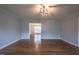 Open living room with hardwood floors and access to dining area at 802 S Sellars Mill Rd, Burlington, NC 27217