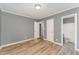 Bright bedroom with wood-look floors and access to bathroom at 805 N Mebane St, Burlington, NC 27217