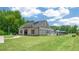 Stunning pool house with a dark roof, grey siding, and black trim on a manicured lawn next to the community pool at 852 Old Tarboro Rd, Wendell, NC 27591