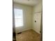 Laundry room with tile flooring and overhead shelving at 918 S Philwood Ct, Fuquay Varina, NC 27526