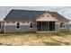 Rear view of a new home showcasing a covered patio and gray siding at 101 Surles Landing Way, Benson, NC 27504