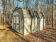 Tan colored shed with double doors, nestled in the woods at 1018 Christy Ridge Ct, Rougemont, NC 27572