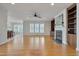 Spacious living room with hardwood floors, fireplace, and built-in shelving at 1024 Bellenden Dr, Durham, NC 27713