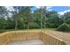 Wooden deck overlooking the backyard with green vegetation at 121 Tanglewood Dr # 8-J, Louisburg, NC 27549