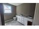 Bathroom with double sink vanity, tile flooring, and window at 121 Tanglewood Dr # 8-J, Louisburg, NC 27549
