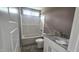 This bathroom offers a white vanity with gray countertop and tub and shower combo at 121 Tanglewood Dr # 8-J, Louisburg, NC 27549