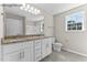Bathroom with a double granite vanity, large mirror, and neutral color scheme at 121 Tanglewood Dr # 8-J, Louisburg, NC 27549