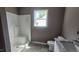 Bathroom featuring a tiled shower, vanity, and a window at 121 Tanglewood Dr # 8-J, Louisburg, NC 27549
