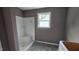 Bathroom featuring a white shower/tub, painted walls, and a window for natural light at 121 Tanglewood Dr # 8-J, Louisburg, NC 27549