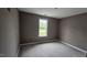 A standard bedroom with light walls, a window, and unfinished flooring ready for customization at 121 Tanglewood Dr # 8-J, Louisburg, NC 27549