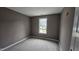 This is a bedroom with one window, neutral colored walls, and unfinished flooring at 121 Tanglewood Dr # 8-J, Louisburg, NC 27549