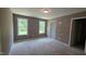 Bedroom featuring a neutral carpet, two windows, and white trim at 121 Tanglewood Dr # 8-J, Louisburg, NC 27549