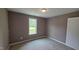 Bedroom with carpet, window, and neutral colored walls at 121 Tanglewood Dr # 8-J, Louisburg, NC 27549