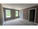 Bedroom with gray walls, a closet, and two windows at 121 Tanglewood Dr # 8-J, Louisburg, NC 27549