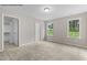 Bright bedroom with neutral tones, carpet, and natural light from the double windows at 121 Tanglewood Dr # 8-J, Louisburg, NC 27549