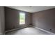 This bedroom features a picture window to let natural light into the space at 121 Tanglewood Dr # 8-J, Louisburg, NC 27549