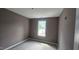 This bedroom features a picture window to let natural light into the space at 121 Tanglewood Dr # 8-J, Louisburg, NC 27549