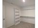 Walk-in closet with carpet, shelving and built-in bookcase at 121 Tanglewood Dr # 8-J, Louisburg, NC 27549