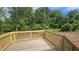 A newly-constructed wooden deck overlooks a spacious and verdant backyard at 121 Tanglewood Dr # 8-J, Louisburg, NC 27549