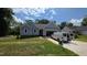 Charming single-story home with light blue siding and an attached garage on a sunny day at 121 Tanglewood Dr # 8-J, Louisburg, NC 27549