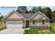 New construction home with green siding and a two-car garage at 121 Tanglewood Dr # 8-J, Louisburg, NC 27549