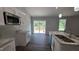 Modern kitchen with stainless steel appliances, ample counter space, and sliding glass doors to the outside deck at 121 Tanglewood Dr # 8-J, Louisburg, NC 27549
