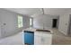 Kitchen with granite countertops, white cabinets, an island, and lots of natural light coming through the windows at 121 Tanglewood Dr # 8-J, Louisburg, NC 27549