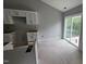 Kitchen with white cabinets and island with view of the outdoor scenery through sliding glass doors at 121 Tanglewood Dr # 8-J, Louisburg, NC 27549