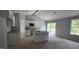 Bright kitchen featuring white cabinets, granite countertops and island, stainless appliances, and natural light at 121 Tanglewood Dr # 8-J, Louisburg, NC 27549