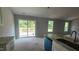 Spacious kitchen featuring granite countertops, white cabinets, an island, sliding glass doors to deck, and lots of light at 121 Tanglewood Dr # 8-J, Louisburg, NC 27549