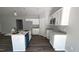 Contemporary kitchen featuring white cabinets, stainless steel appliances, granite counters, and island with sink at 121 Tanglewood Dr # 8-J, Louisburg, NC 27549