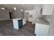 Open kitchen with an island with a sink and dishwasher, white cabinets, and hardwood floors at 121 Tanglewood Dr # 8-J, Louisburg, NC 27549