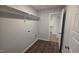 Laundry room with wood flooring and shelving at 121 Tanglewood Dr # 8-J, Louisburg, NC 27549