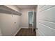 Well-lit laundry room with vinyl flooring, utility connections, and a view to another room providing functionality at 121 Tanglewood Dr # 8-J, Louisburg, NC 27549