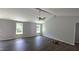 Light and airy living room featuring hardwood floors, two windows and a vaulted ceiling with fan. (Illustration Only) at 121 Tanglewood Dr # 8-J, Louisburg, NC 27549