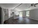 Bright, open-concept living room featuring modern dark wood floors and a connected kitchen with an island at 121 Tanglewood Dr # 8-J, Louisburg, NC 27549