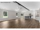 Open-concept living room showcasing sleek flooring, abundant natural light, and access to kitchen at 121 Tanglewood Dr # 8-J, Louisburg, NC 27549