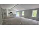 Living room with abundant natural light, slider door access to backyard, and kitchen with island at 121 Tanglewood Dr # 8-J, Louisburg, NC 27549